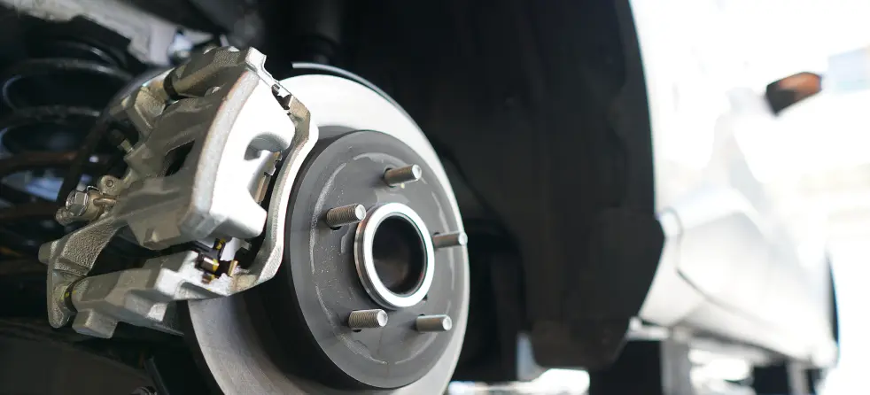 Close-up view of a car's brake disc, showcasing its intricate design and surface texture for optimal braking performance.