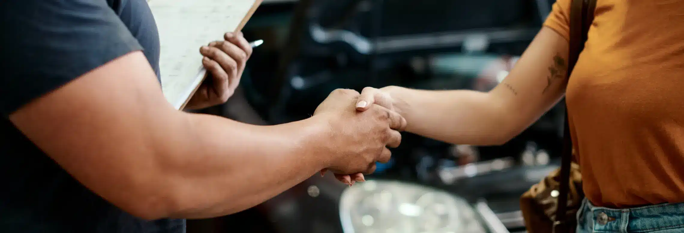 a handshake between a customer and auto service provider