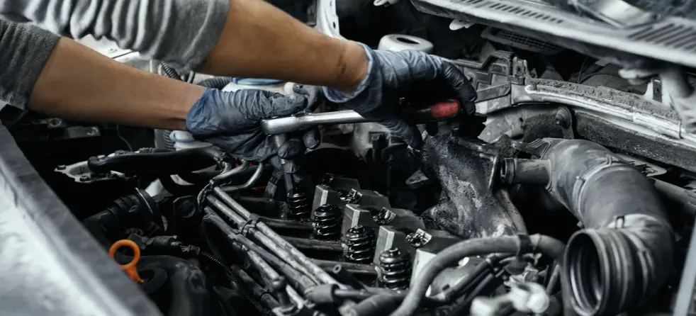 An individual engaged in car engine repair