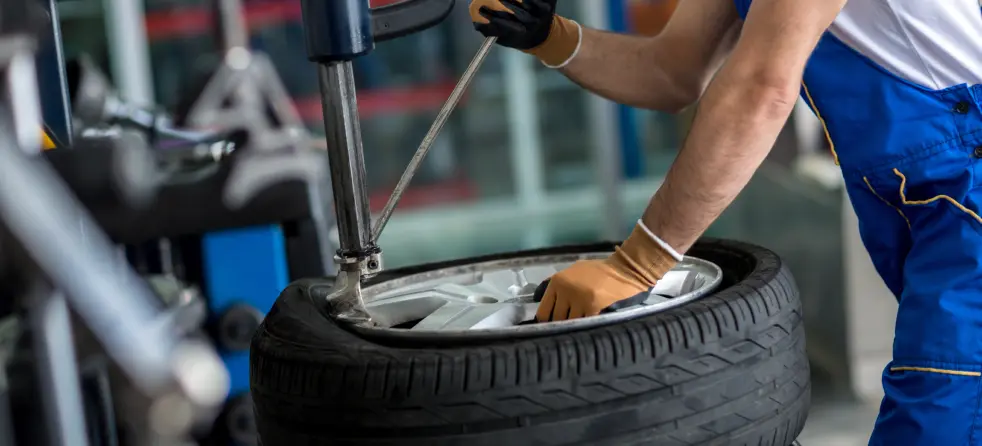 A mechanic working on a tire