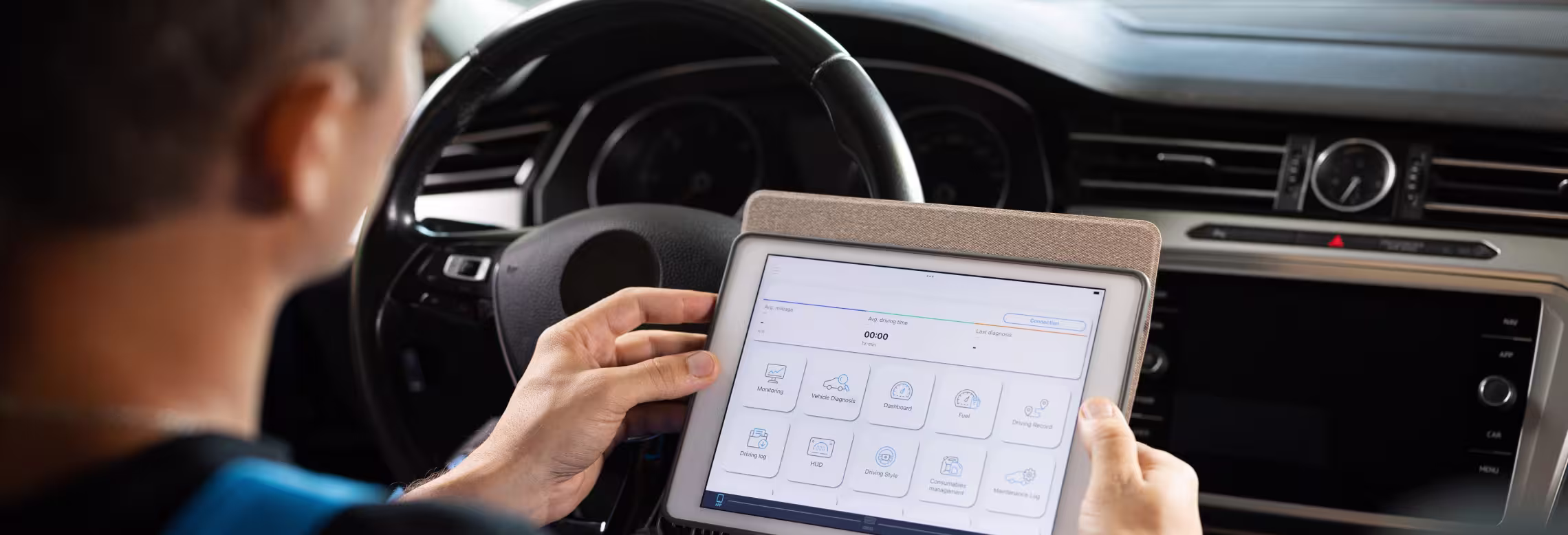 software updates and programming. A man utilizing a tablet for diagnostics