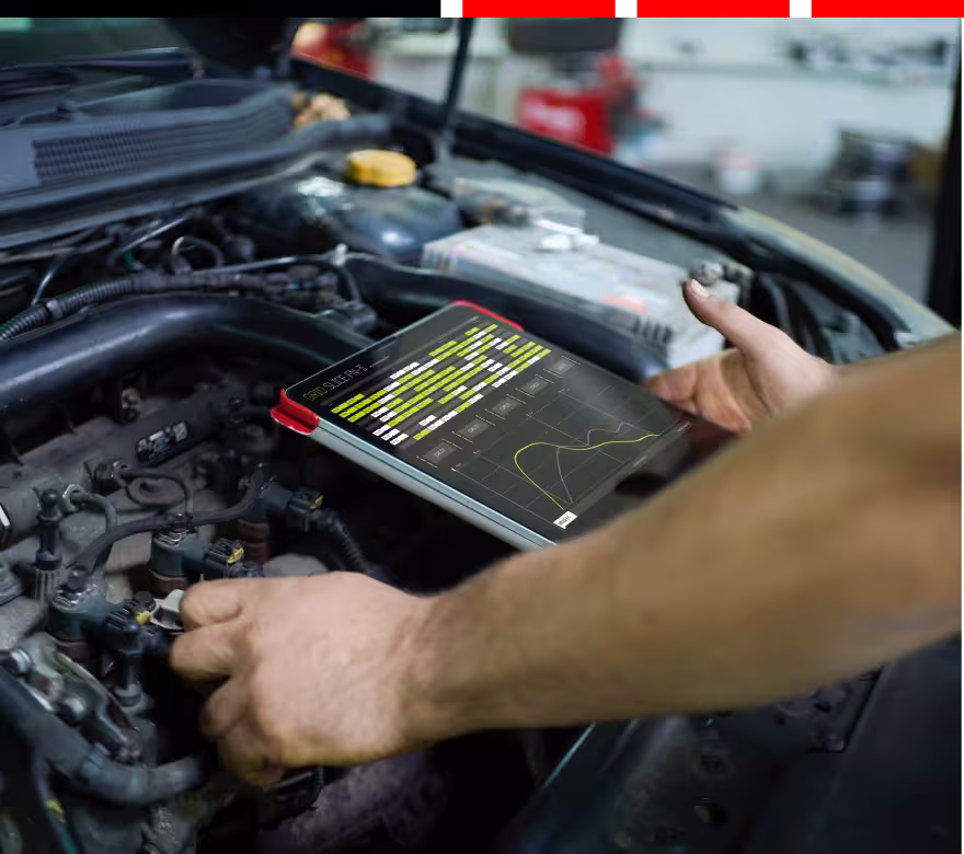 software updates and programming, auto repair in Milwaukee, WI at Next Level Auto Services. A technician on the hood of a vehicle checking his diagnostic tool