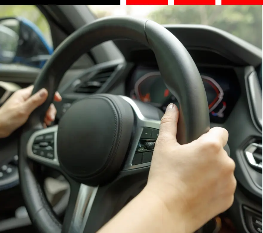 suspension & steering repair. auto repair in Milwaukee, WI at Next Level Auto Services. A close up hand of a person driving a vehicle.