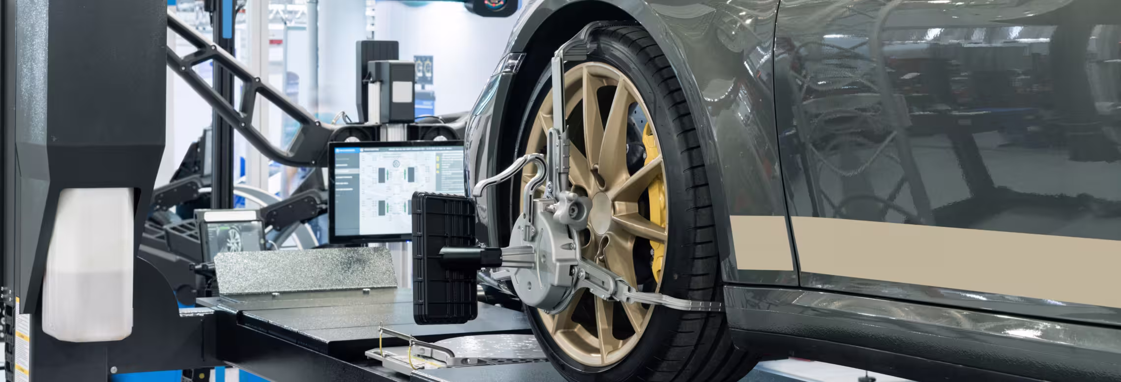 Vehicle on a wheel alignment platform at Next Level Auto Services in Milwaukee.