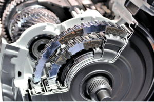transmission stuck gears, auto repair in Milwaukee, WI at Next Level Auto Services. Automatic transmission system components showing internal clutch plates and gear assembly in a detailed cross-section.