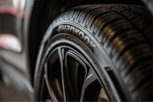 tires, auto repair in Milwaukee, WI at Next Level Auto Services. Close-up of a Hankook tire mounted on a vehicle, highlighting clean tread pattern and sidewall branding in a well-lit garage setting.