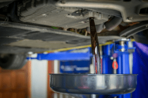 Transmission Fluid Service in Milwaukee WI At Next Level Auto Services. Mechanic draining old transmission fluid during a service in Milwaukee